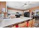 Cozy kitchen with a kitchen island with bar stool seating, white cabinets, black appliances, and hardwood floors at 719 Juniper Dr., Myrtle Beach, SC 29575