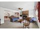 Open-concept living room with a brick fireplace, built-in shelving, and view into the dining and kitchen areas at 719 Juniper Dr., Myrtle Beach, SC 29575
