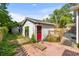 A view of the backyard outbuilding with a red door and brick flooring at 719 Juniper Dr., Myrtle Beach, SC 29575