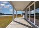 View from covered back porch with ceiling and view of grassy yard and lake at 748 Choctaw Dr., Conway, SC 29526