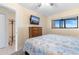 Comfortable bedroom features neutral walls, wood dresser, and a window for natural lighting at 7509 N Ocean Blvd. # 404, Myrtle Beach, SC 29572
