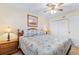 Bright bedroom features a full bed with seashell quilt, two nightstands, and a closet at 7509 N Ocean Blvd. # 404, Myrtle Beach, SC 29572
