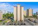 High-rise condo building showing parking, pool, and landscaping on a bright, sunny day at 7509 N Ocean Blvd. # 404, Myrtle Beach, SC 29572