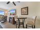 Open dining area with a high-top table, TV, and relaxing recliner next to a scenic balcony at 7509 N Ocean Blvd. # 404, Myrtle Beach, SC 29572