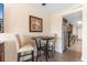 Compact dining table with two chairs is situated next to a glimpse of the kitchen area at 7509 N Ocean Blvd. # 404, Myrtle Beach, SC 29572