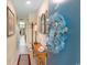 Inviting hallway features tiled floors, a wooden console table, mirror and 'beach' themed wreath at 7509 N Ocean Blvd. # 404, Myrtle Beach, SC 29572