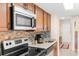 This kitchen features stainless steel appliances, granite countertops, and mosaic backsplash at 7509 N Ocean Blvd. # 404, Myrtle Beach, SC 29572