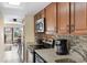 Bright kitchen has granite countertops, wood cabinets, and stainless steel appliances at 7509 N Ocean Blvd. # 404, Myrtle Beach, SC 29572
