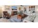 Cozy living room has an electric fireplace, mounted TV, and comfortable furniture and dining area at 7509 N Ocean Blvd. # 404, Myrtle Beach, SC 29572