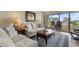 Bright living room showing furnishings, natural light, and a view to the balcony with seating at 7509 N Ocean Blvd. # 404, Myrtle Beach, SC 29572