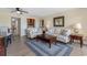 Living room featuring comfortable seating, a ceiling fan, and an adjacent bar area with tile backsplash at 7509 N Ocean Blvd. # 404, Myrtle Beach, SC 29572