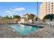 Beautiful outdoor pool area with plenty of seating and a privacy fence at 7509 N Ocean Blvd. # 404, Myrtle Beach, SC 29572