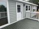 Back porch door and multiple windows with white trim offer exterior access and natural light at 803 34Th Ave. S, North Myrtle Beach, SC 29582
