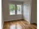 Bedroom showcasing hardwood floors, closet, natural light, and paneled walls at 803 34Th Ave. S, North Myrtle Beach, SC 29582