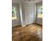 Bright bedroom with hardwood floors, neutral paint, beadboard accent, and a double door closet at 803 34Th Ave. S, North Myrtle Beach, SC 29582