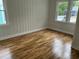 Bedroom featuring hardwood floors, natural light, and paneled walls at 803 34Th Ave. S, North Myrtle Beach, SC 29582
