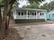 Inviting single-story home featuring a covered porch, well-maintained landscaping, and a welcoming facade at 803 34Th Ave. S, North Myrtle Beach, SC 29582