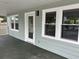 Inviting front porch with white trim and a view looking out onto the quiet neighborhood streets at 803 34Th Ave. S, North Myrtle Beach, SC 29582