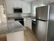 Updated kitchen featuring stainless steel appliances, granite countertops, and white cabinetry at 803 34Th Ave. S, North Myrtle Beach, SC 29582