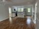 Open floorplan showcasing the updated kitchen with stainless steel appliances and bright white cabinets at 803 34Th Ave. S, North Myrtle Beach, SC 29582