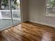 Bright living room showcasing hardwood floors and sliding glass doors to outdoor deck at 803 34Th Ave. S, North Myrtle Beach, SC 29582
