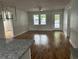 Sunlit living room with hardwood floors, beadboard accent, ceiling fan and access to back door at 803 34Th Ave. S, North Myrtle Beach, SC 29582