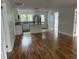 Open-concept living area with gleaming hardwood floors seamlessly connected to a bright, modern kitchen at 803 34Th Ave. S, North Myrtle Beach, SC 29582