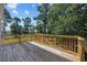 Spacious wooden deck with natural finish, overlooking lush greenery and mature trees at 854 Falkirk St., Myrtle Beach, SC 29579