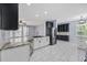 Stylish kitchen features white cabinets, granite countertops, stainless appliances, and tile floors at 854 Falkirk St., Myrtle Beach, SC 29579