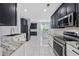 Well-lit kitchen featuring modern appliances, granite countertops and tile flooring at 854 Falkirk St., Myrtle Beach, SC 29579
