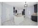 Open-concept kitchen with an island, modern appliances, tile flooring, and natural light at 854 Falkirk St., Myrtle Beach, SC 29579