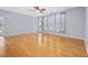 Bright living room with hardwood floors, a ceiling fan, a sliding glass door, and large windows at 854 Falkirk St., Myrtle Beach, SC 29579