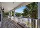 Relaxing outdoor porch with white railing overlooking tropical palm trees and neighborhood street at 854 Falkirk St., Myrtle Beach, SC 29579
