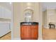 This interior shot showcases a wooden bar cabinet featuring a sink and a black countertop at 8546 San Marcello Dr. # 1-102, Myrtle Beach, SC 29579