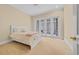 Bright bedroom featuring a queen bed and white french doors to the patio at 8546 San Marcello Dr. # 1-102, Myrtle Beach, SC 29579