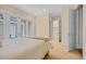 Bright bedroom featuring a queen bed and white french doors leading to the patio at 8546 San Marcello Dr. # 1-102, Myrtle Beach, SC 29579
