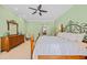 Serene bedroom with a four-poster bed, soft green walls, and plenty of natural light, providing a relaxing retreat at 8546 San Marcello Dr. # 1-102, Myrtle Beach, SC 29579