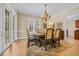 Inviting dining room featuring a chandelier and ample natural light from the adjacent windows and glass door at 8546 San Marcello Dr. # 1-102, Myrtle Beach, SC 29579