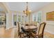 Charming dining area with elegant furnishings, chandelier lighting, and easy access to the outdoors at 8546 San Marcello Dr. # 1-102, Myrtle Beach, SC 29579