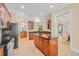 Well-appointed kitchen boasting dark wood cabinets, granite countertops, and modern stainless steel appliances at 8546 San Marcello Dr. # 1-102, Myrtle Beach, SC 29579