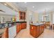 Well-lit kitchen featuring custom cabinets, black countertops, a spacious island, and stainless steel dishwasher at 8546 San Marcello Dr. # 1-102, Myrtle Beach, SC 29579
