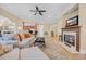 Open concept living room with fireplace, tile flooring, and adjacent kitchen area, perfect for entertaining at 8546 San Marcello Dr. # 1-102, Myrtle Beach, SC 29579