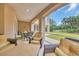 Covered outdoor patio with comfortable seating, a stone table, and views of the beautiful landscaped backyard at 8546 San Marcello Dr. # 1-102, Myrtle Beach, SC 29579