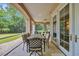 Relaxing covered patio with a dining table set and outdoor seating, overlooking a lush green lawn at 8546 San Marcello Dr. # 1-102, Myrtle Beach, SC 29579