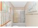 Bathroom featuring a shower with glass doors and decorative curtains at 934 Tiffany Ln., North Myrtle Beach, SC 29582