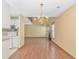 Open-concept dining area with hardwood floors, chandelier, and easy access to the kitchen at 934 Tiffany Ln., North Myrtle Beach, SC 29582