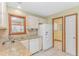 Efficient kitchen with granite countertops, tile flooring, and white appliances at 934 Tiffany Ln., North Myrtle Beach, SC 29582