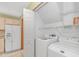 Laundry room with modern appliances, cabinets and white shelving at 934 Tiffany Ln., North Myrtle Beach, SC 29582