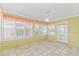 Light filled sunroom featuring tile floors, bead board and lots of windows at 934 Tiffany Ln., North Myrtle Beach, SC 29582