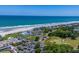 Aerial view featuring oceanfront access, community pools, golf course, and coastal homes at 9340 Lake Dr., Myrtle Beach, SC 29572